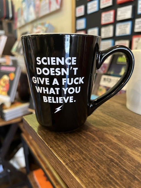 Black mug with the text 'Science doesn\'t give a fuck what you believe.'